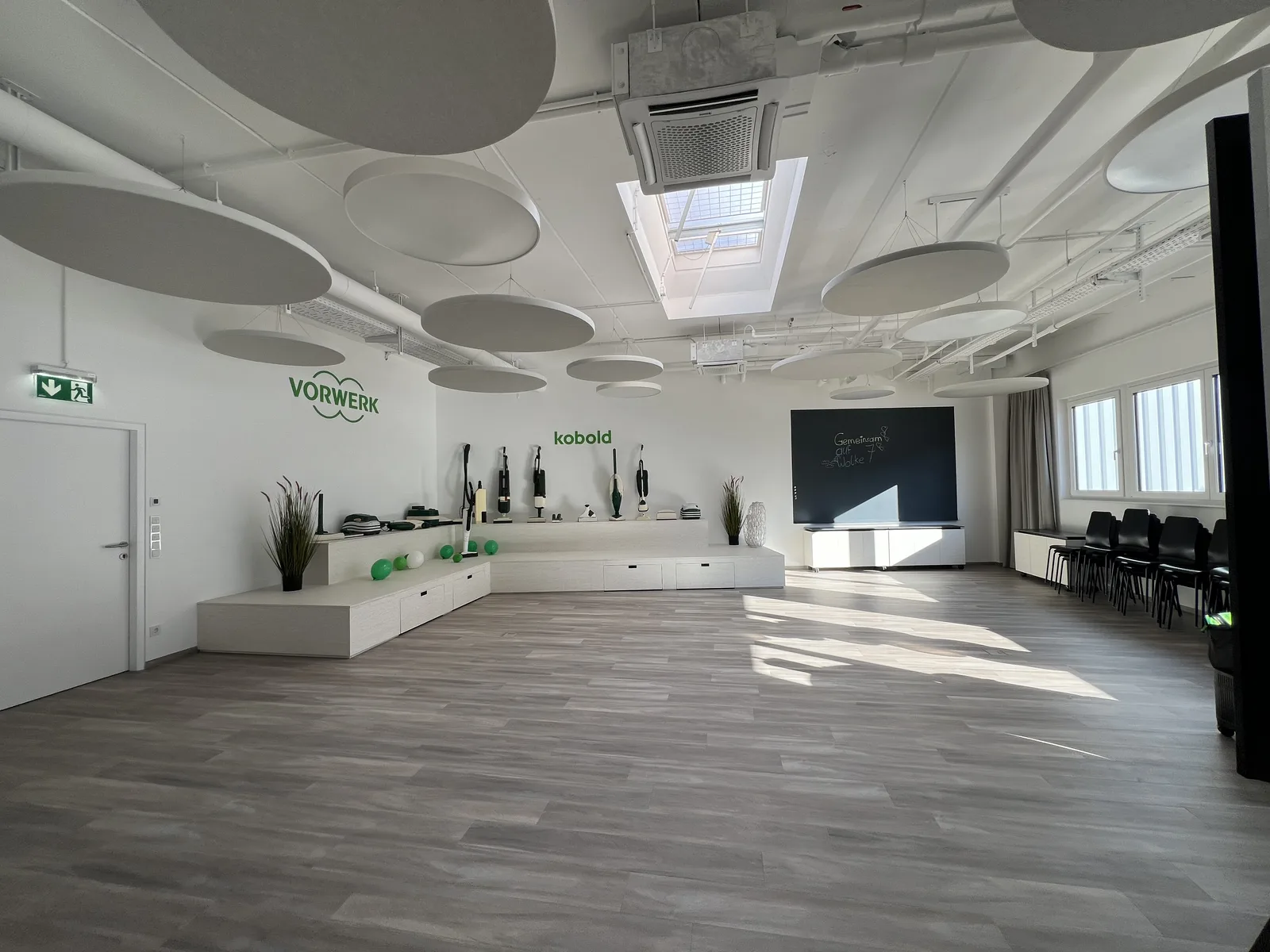 Bright Vorwerk and Kobold presentation room with technical ceiling installations